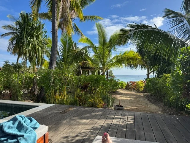 Tropical gardens and a walkway towards the ocean at Six Senses Fiji